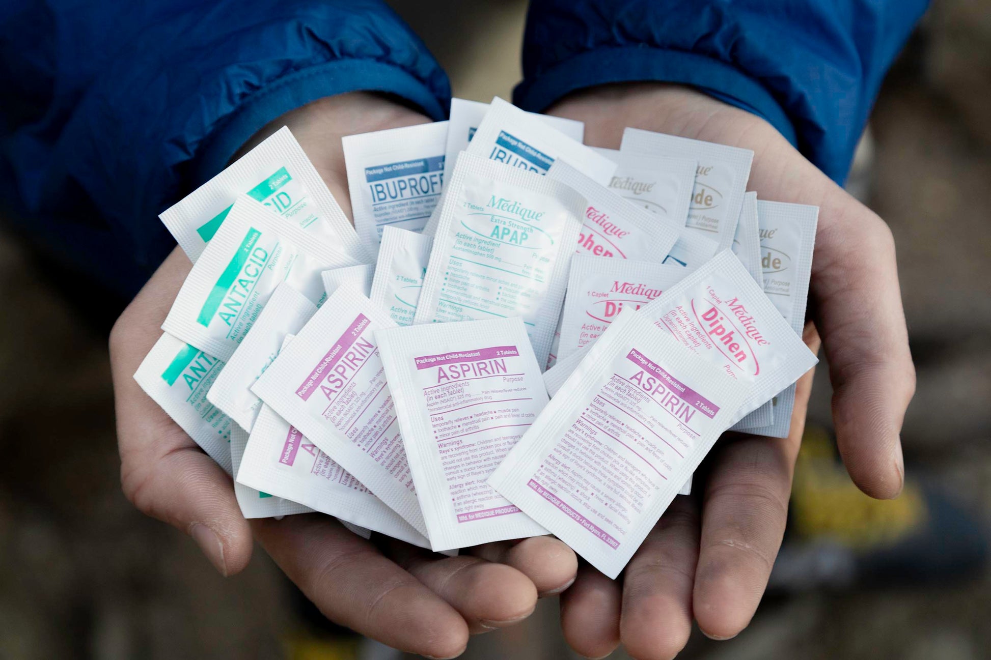 Hands holding all of the medications in the refill pack