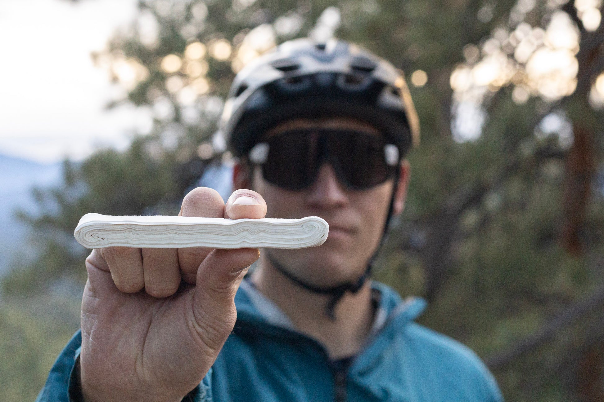 A man holds out peak tape