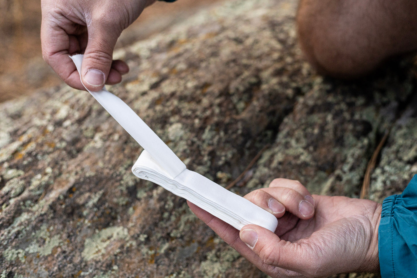 A man unwraps Peak Tape A flat packed athletic tape