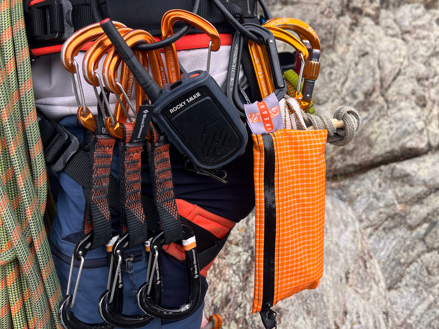 A peak first aid kit on a climbers harness close up